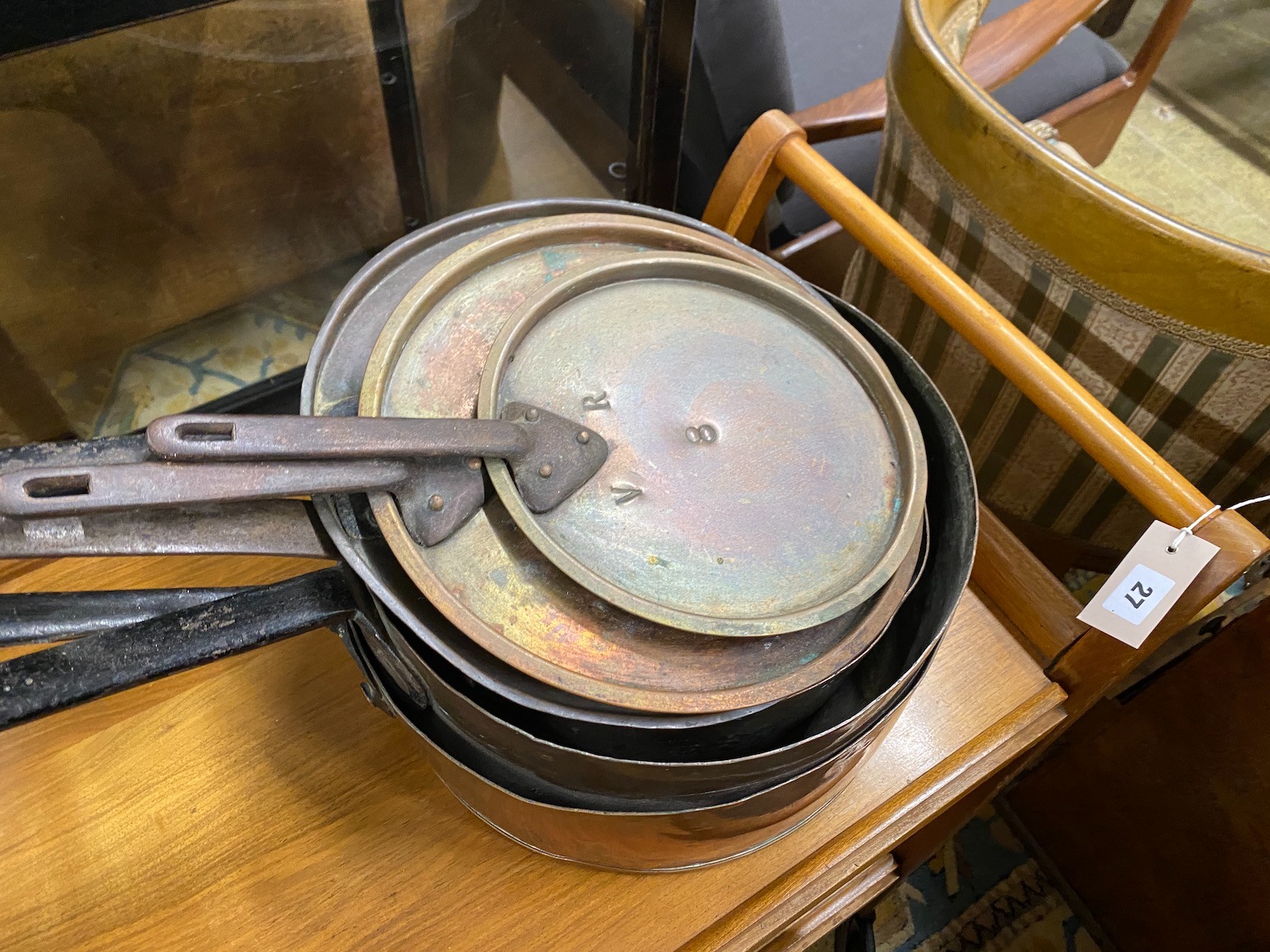 Three graduated Victorian lidded copper pans, largest diameter 31cm